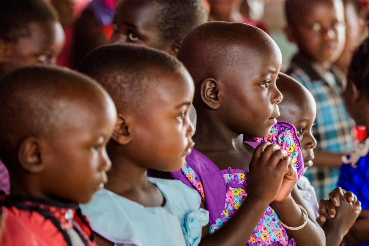 Children pray together in Uganda