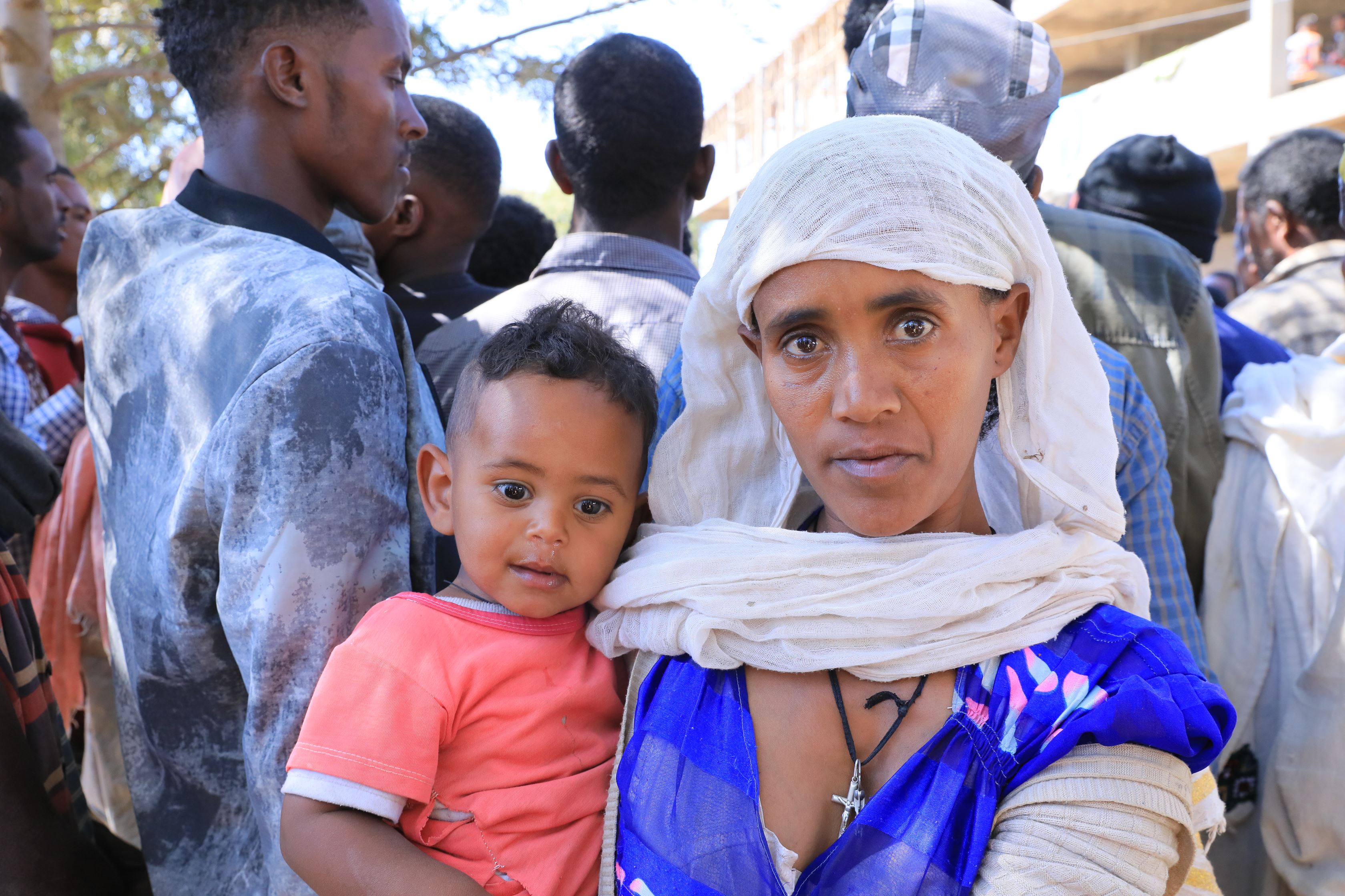 A displaced woman and her child receive support from World Vision
