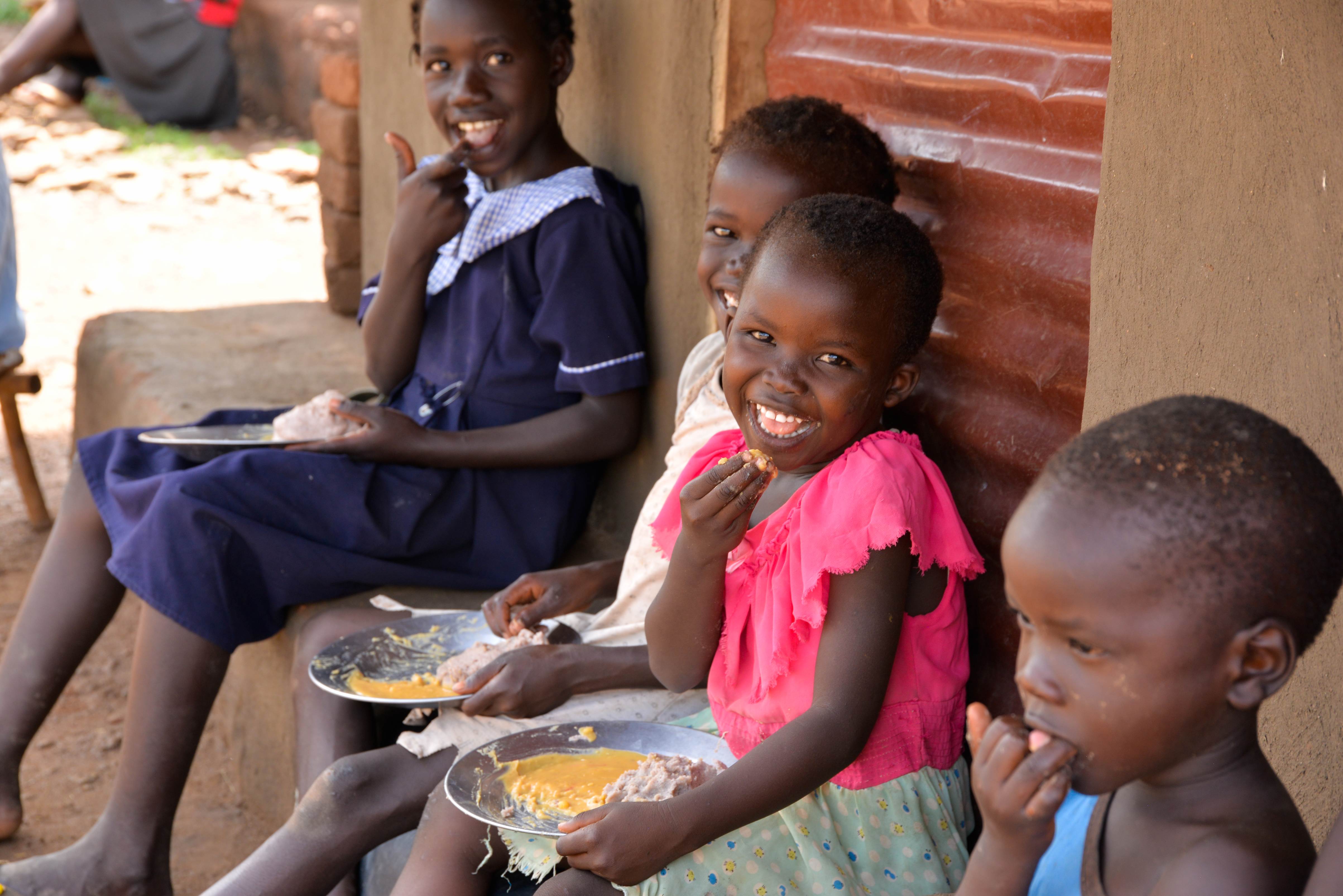 Children in Uganda, enjoy food in their own plates for lunch