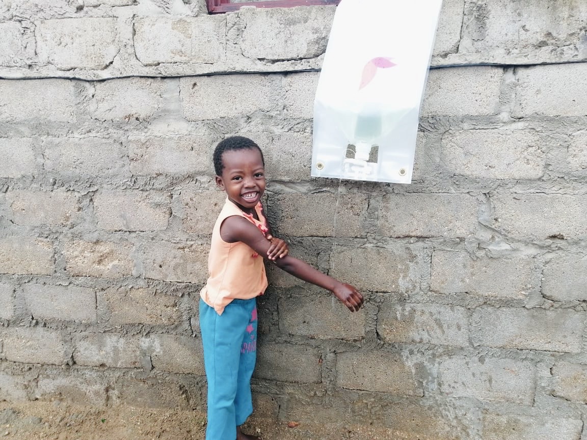Young girl washing her hands using 
