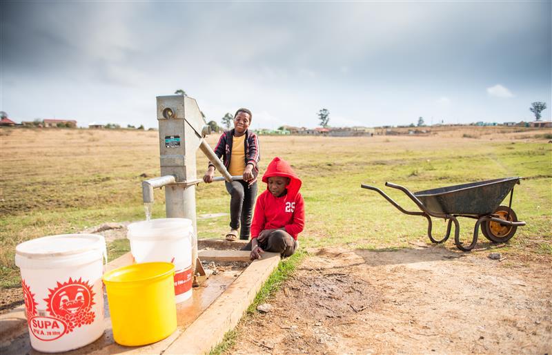 Two boys at the handpump in South Africa